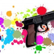 Toy gun on paint-splattered background