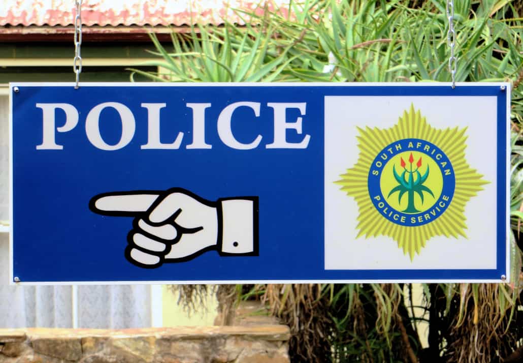A sign pointing towards a police station