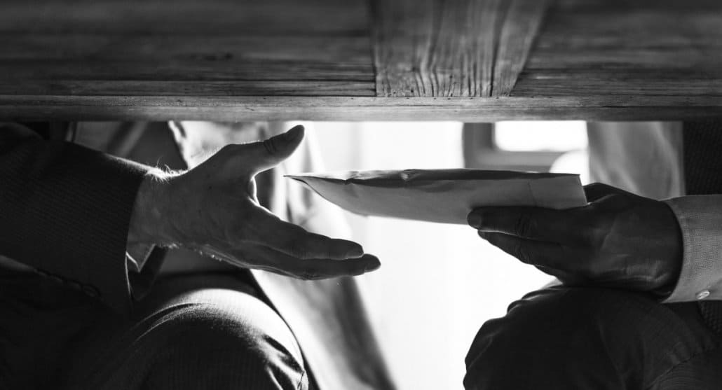 Men passing money under the table