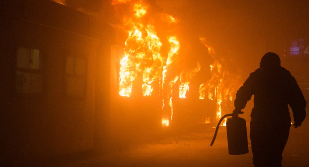 Photo of a man running to put out a train on fire