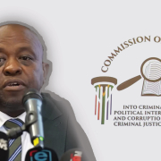 Justice Mbuyiseli Madlanga, next to the banner and logo of the Madlanga commission into criminality in the criminal justice system