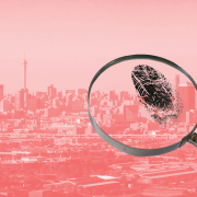 A magnifying glass examining a fingerprint, superimposed on a representation of the Johannesburg skyline